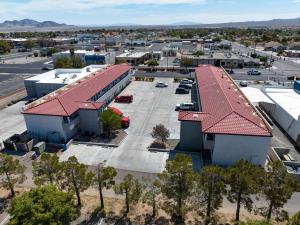 an aerial view of a building with a parking lot at Baymont by Wyndham Ridgecrest in Ridgecrest