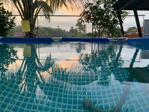 a reflection of a person in a swimming pool at Palas Tiny Homestay in Changlun