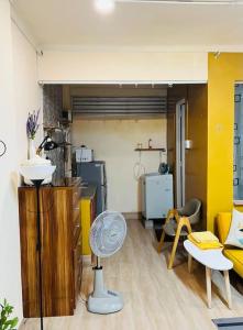 a living room with a fan in a room at Lagom studio 24 - bathtub-balcony, Nguyen Du, Ben Nghe Ward, dist 1 in Ho Chi Minh City