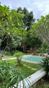 une piscine au milieu d'un jardin dans l'établissement Shaya Suandoi Resort, à Pai