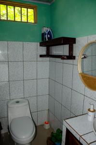 a bathroom with a toilet and a sink and a mirror at Natural Harmony Cabin in Puerto Jiménez +33 photos