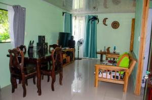 a living room with a table and a television at Natural Harmony Cabin in Puerto Jiménez
