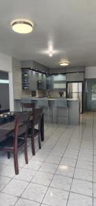 a large kitchen with wooden tables and benches in a room at Kali-Yaiti Casa Vacacional in Vega Baja