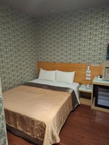 1 dormitorio con 1 cama en una habitación en Yung Feng Hotel, en Keelung