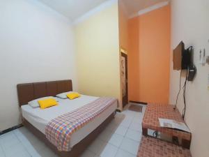 Postel nebo postele na pokoji v ubytování Homestay at Homy House by ecommerceloka