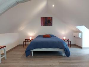 a bedroom with a blue bed and two tables at Charmant gîte au cœur de Saint-Christophe, 6 pers, tout confort, Wi-Fi gratuit, proche châteaux et nature - FR-1-581-116 in Saint-Christophe
