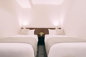 Postel nebo postele na pokoji v ubytování R Hotel Honmachi