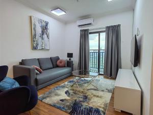 ein Wohnzimmer mit einem Sofa und einem Fenster in der Unterkunft Le Quadri Hotel Kuala Lumpur in Kuala Lumpur
