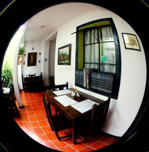 a dining room with a table and a window at Hotel Belen in Popayan