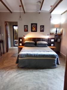 a bedroom with a large bed in a room at Lebombo Wattle Cottage - Forest 1 in Hluhluwe