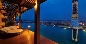 a balcony with a view of the city at night at Tribeca Serviced Hotel by Millennium in Kuala Lumpur