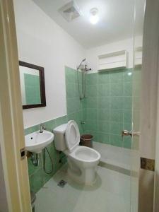 a bathroom with a toilet and a sink at Stylish 2BR w/ Free Pool Access and Parking LG03 in Manila