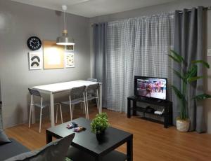 a living room with a table and a dining room at Stylish 2BR w/ Free Pool Access and Parking LG03 in Manila