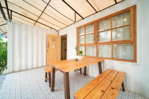 a wooden table and a bench in a room at Danka Vacation Home in Seribu