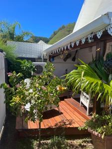 a porch with a wooden deck with plants on it at chalet chenal in Hauru