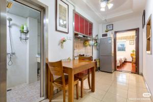 a kitchen and dining room with a wooden table and chairs at West Lake Hefang Street Metro Exit B&B in Hangzhou