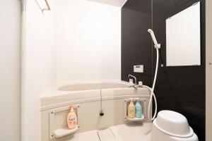 a white bathroom with a toilet and a sink at S-villa Nasu 12th in Nasu-yumoto