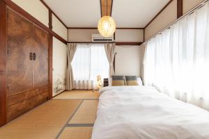 a bedroom with a large bed and a window at Honmachi House in Tokyo