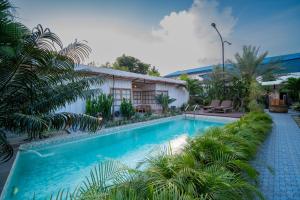 a swimming pool in front of a house at Danka Vacation Home in Seribu