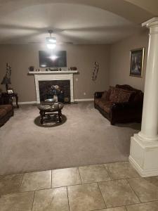a living room with a couch and a fireplace at Anthony apartment in Macomb