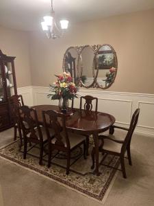 a dining room with a table and chairs and a mirror at Anthony apartment in Macomb