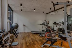 a gym with several exercise equipment in a room at Bisma Eight - CHSE Certified in Ubud