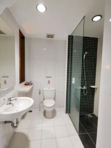 a bathroom with a toilet and a sink and a shower at HOTEL TILAMAS in Dares