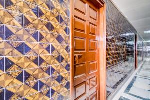 a door to a wine cellar with blue and gold tiles at SPOT ON 63743 Jayesh Lodging And Boarding in Taloje