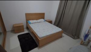 a small bedroom with a bed and a window at Nha Maria Apartament in Praia