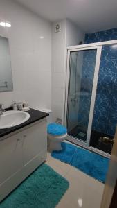 a bathroom with a toilet and a sink and a shower at Nha Maria Apartament in Praia