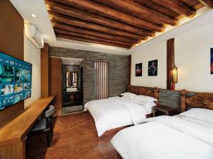 夕露小榭古城南门店 Xilu Xiaoxie Inn Old Town Lijiang客房内的一张或多张床位