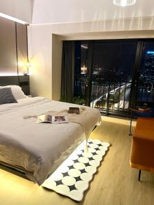 a bedroom with a large bed and a large window at Manriver Executive Apartments in Guangzhou