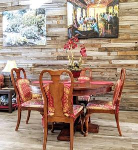 un comedor con mesa, sillas y una pintura en Corner Lake Getaway, en Bella Vista