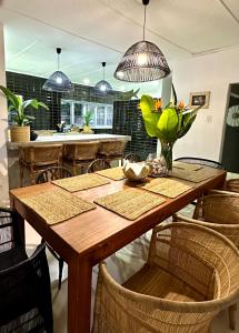 a dining room with a wooden table and chairs at COCOTREE beach house in Clansthal