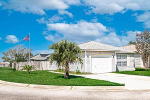 a house with a palm tree in the front yard at Sea Breeze Retreat in Navarre