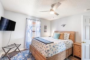 a bedroom with a bed and a flat screen tv at Sea Breeze Retreat in Navarre