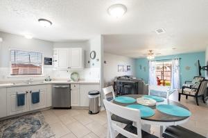 a kitchen and dining room with a table and chairs at Sea Breeze Retreat in Navarre