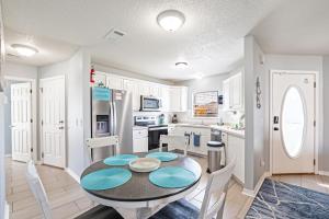 a kitchen and dining room with a table and chairs at Sea Breeze Retreat in Navarre +8 photos