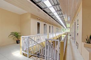 an empty corridor of a building with a balcony at OYO Life 93034 Ayri Home in Salatiga