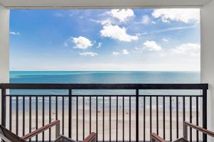 a view of the beach from a balcony at Romantic Oceanfront Studio Escape w Perfect View 1212 in Myrtle Beach