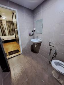 a bathroom with a sink and a toilet and a shower at Hijauan Homestay Shah Alam in Shah Alam