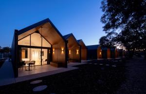 a small house with a glass facade at night at Par Five Shacks in Berri