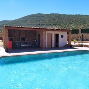 a house with a swimming pool in front of it at Casa Rural La Costa in La Lapa