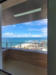 a view of the ocean from a balcony of a building at Lindo e novo apto com vista para o mar de Pituba c/garagem in Salvador