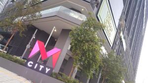 a building with a x city sign on it at M City Ampang KL city in Kuala Lumpur