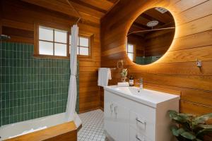 a bathroom with a sink and a shower and a mirror at Golden Pine Retreat in Bright +32 photos