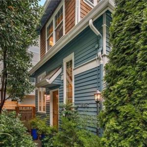 a blue house with a light on the side of it at Modern 3Bed+loft, 3.5Bath Home w/desk, gym access in Seattle