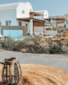 a view of a house with a rattan table in front of it at Thimari Lodge in Fira