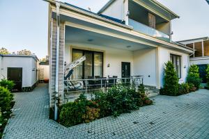 a house with a porch and a patio at VİP Family Home in Gabala