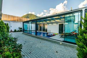 a large glass house with a swimming pool at VİP Family Home in Gabala
